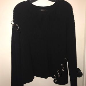 Black knitted sweater with silver hooks